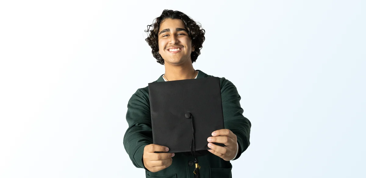 boy with graduate hat in his hands