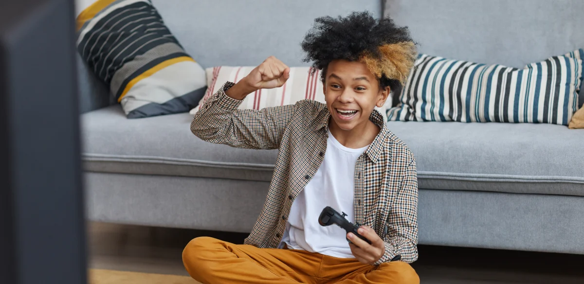 little boy playing videogames