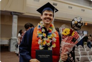Graduate with flowers on his neck