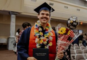 Graduate with flowers on his neck