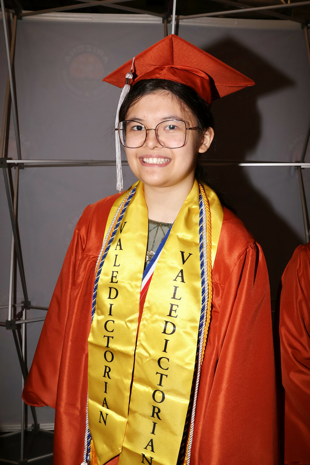 Insight Academy of Arizona 2026 valedictorian and harpist Grace Llames in a cap and gown.