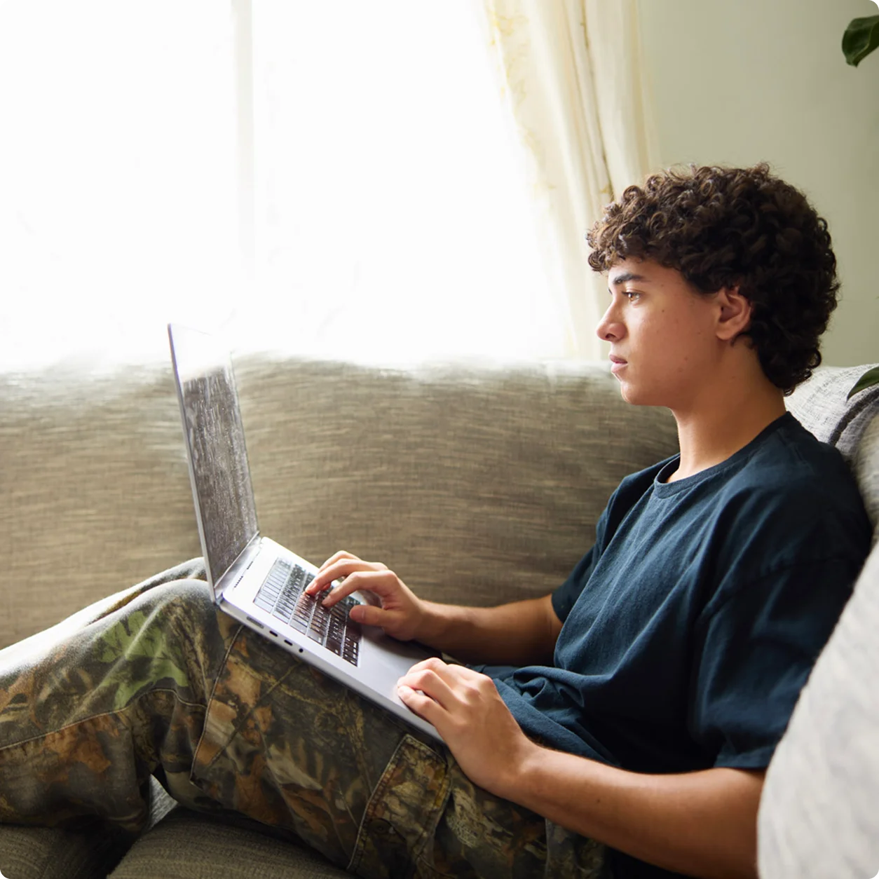 Student at home with his laptop