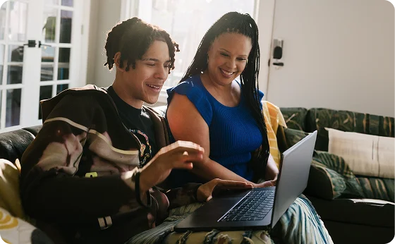 Mother and her child working with their laptop