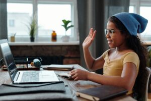 Student raising hand in virtual class