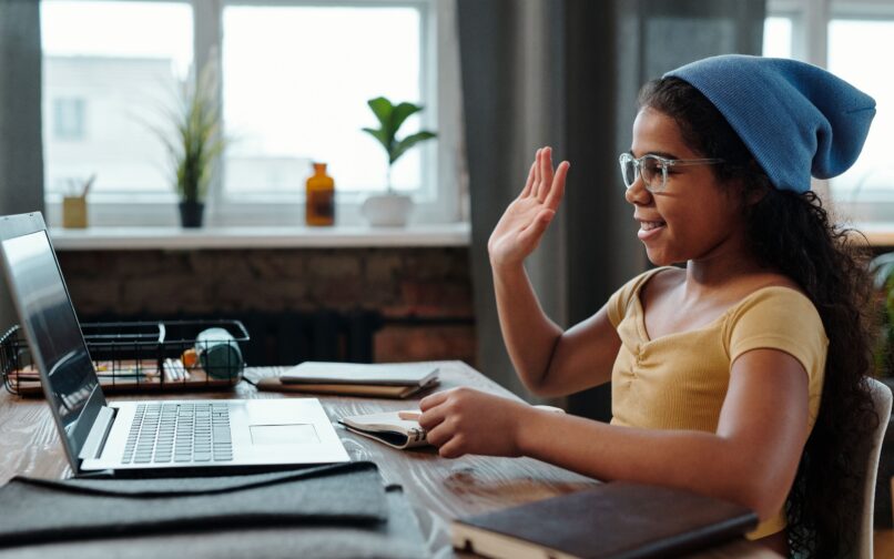 Student raising hand in virtual class