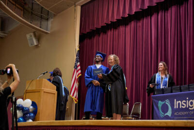 Boy with director receiving a diploma