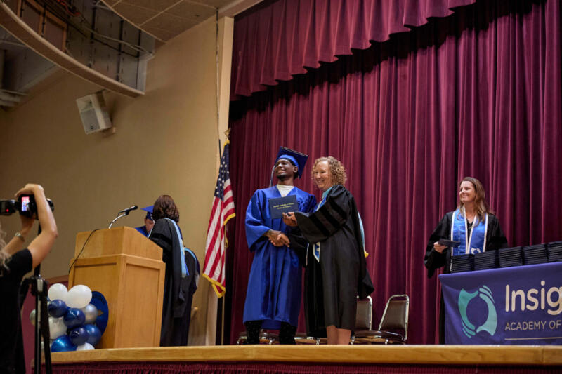 Boy with director receiving a diploma