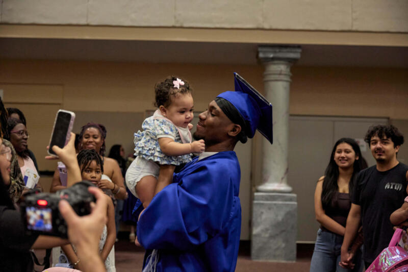 Boy with baby at graduation