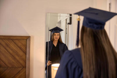 Girl looking herself in the mirror