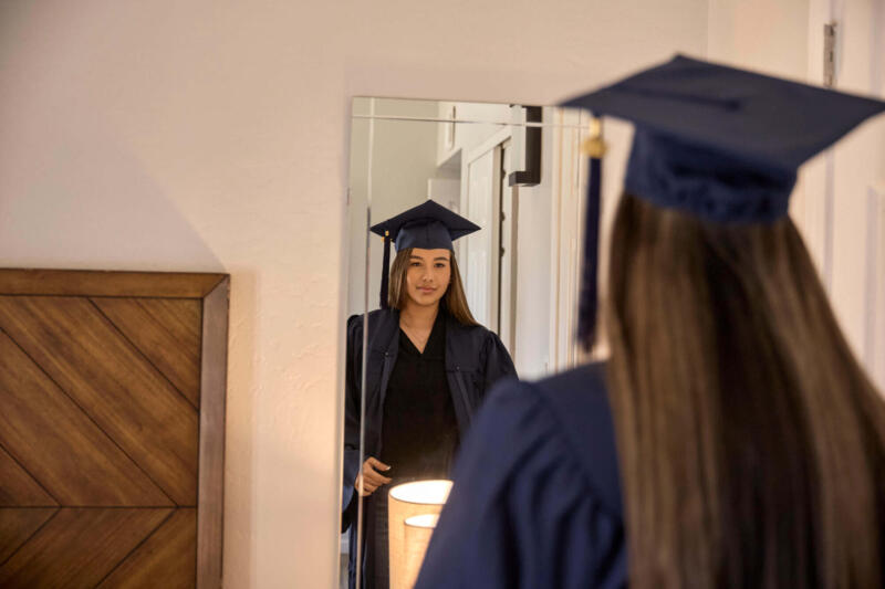 Girl looking herself in the mirror